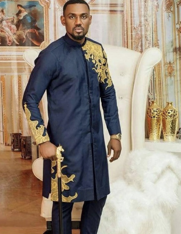 Confident man standing in vibrant, colorful traditional African attire