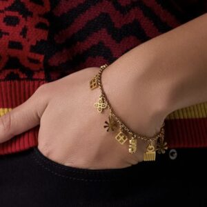 Gold-toned chain bracelet with small handcrafted African-inspired metal charms.